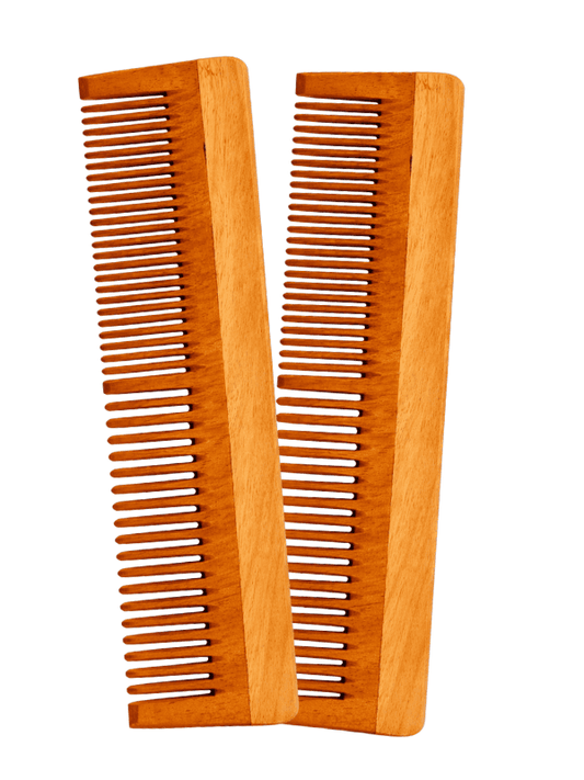 Two wooden combs on a white background