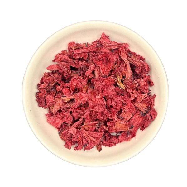 Red dried flowers in a white bowl on a white background